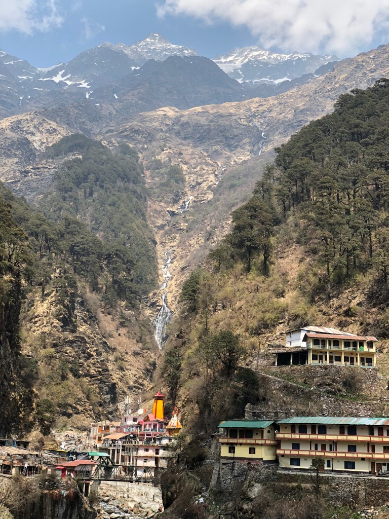 Yamunotri temple and the Yamuna river flowing down from Mount Kalindi peak above