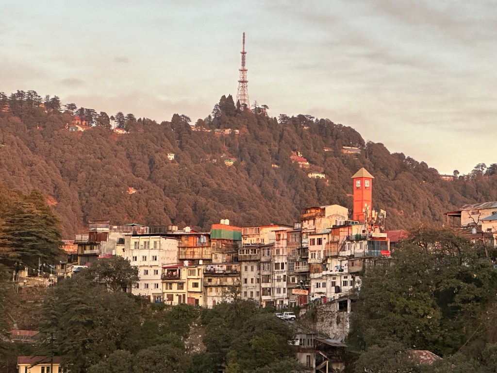 Landour Clock tower and the vicinity, bathed in orangish hue of the fading evening sun. Landour is a quaint little neighbourhood in Mussoorie. #QueenofHills #Uttarakhand #Hillstation