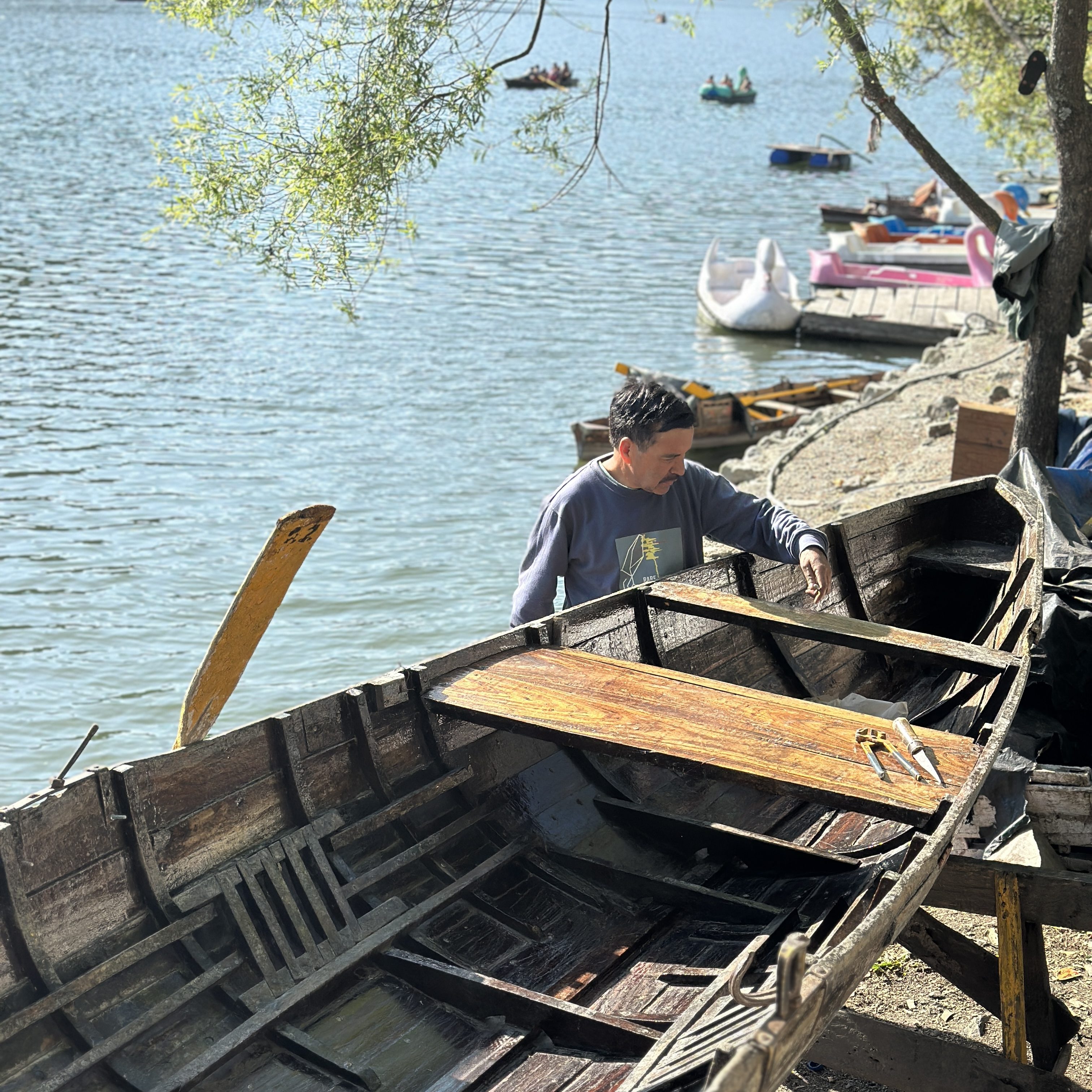 Some busy repairing their boats. #Nainilake #Nainital #Hillstation #boatride #Nainitallake #Pahad #mountainlife #skills #woodenboat #DevbhoomiUttarakhand
